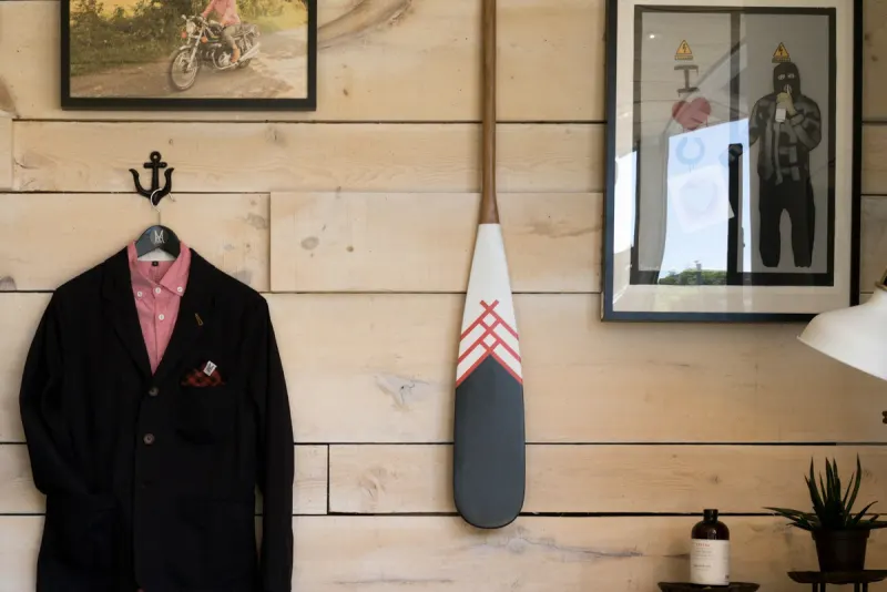Saco negro de terno con camisa colgado en la pared